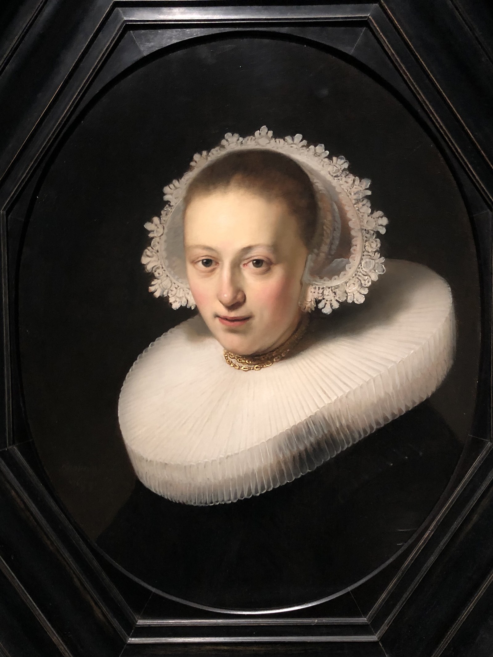 Portrait of a young woman with a pleated collar and a lace cap