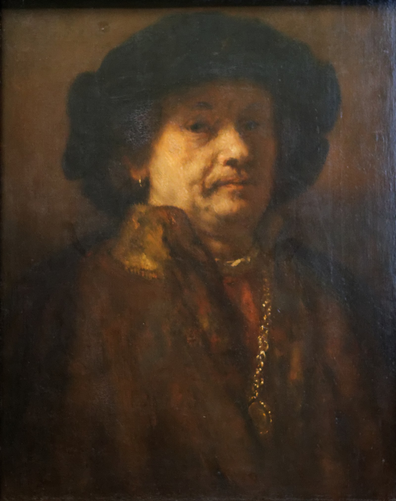 Self-portrait in a fur coat with gold chain and earring