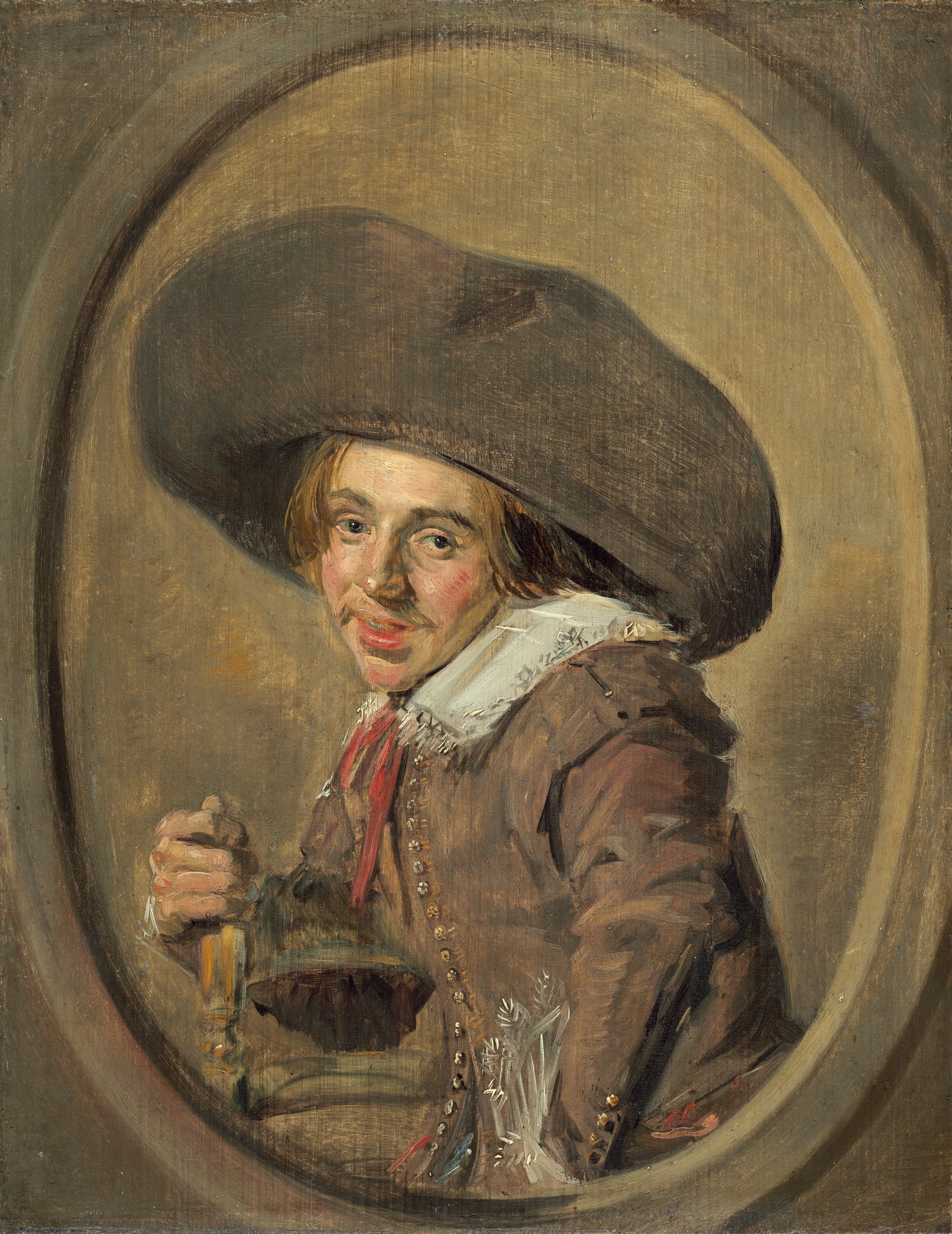 Portrait of a seated young man with a broad brim hat