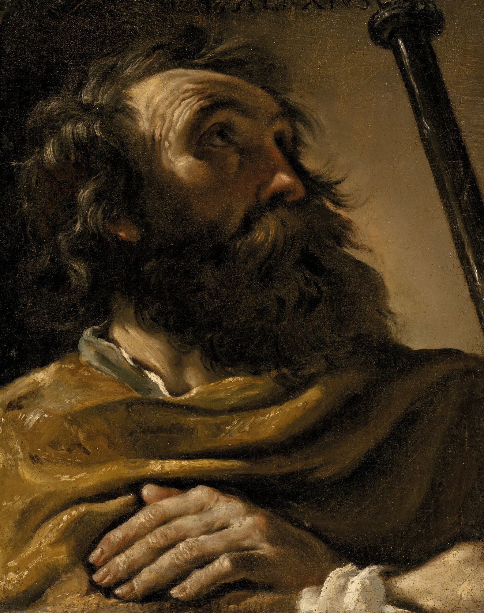Saint Alexius in a brown wrap, holding a staff