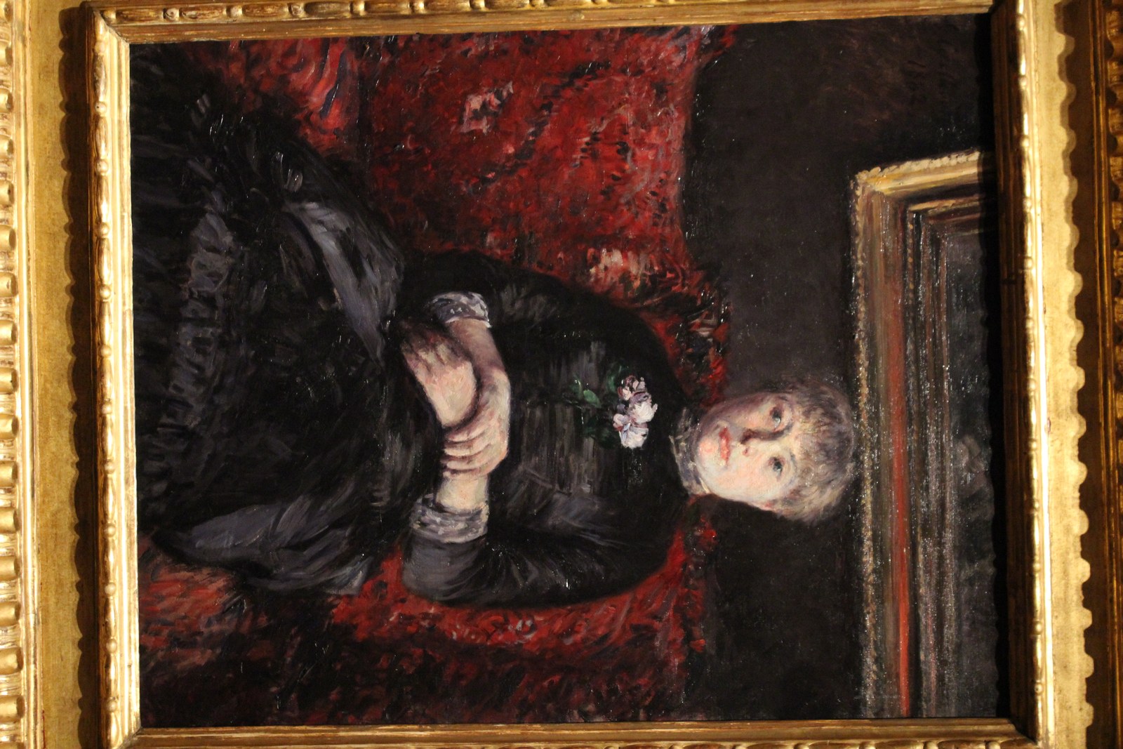 Woman Seated on a Red-Flowered Sofa
