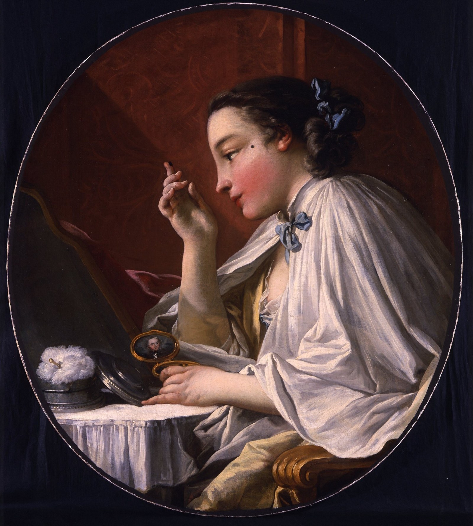 A Lady Applying a Beauty Spot