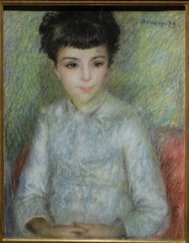 Portrait of young brunette girl, sitting with hands crossed